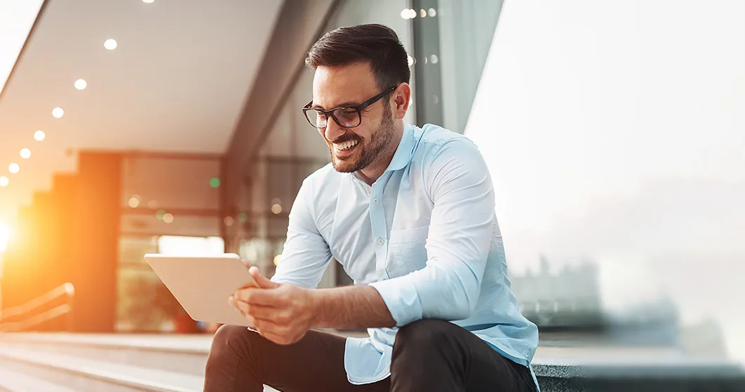 Happy businessman with tablet